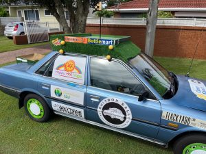 The Golf Bro's hit the Road picture of car decorated as golfing putting green